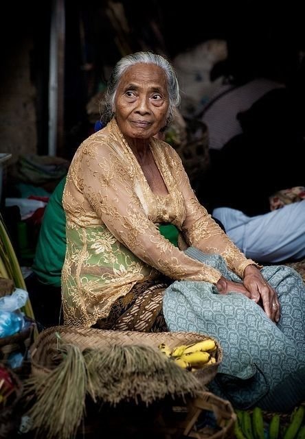 a Balinese grandmother is glancing