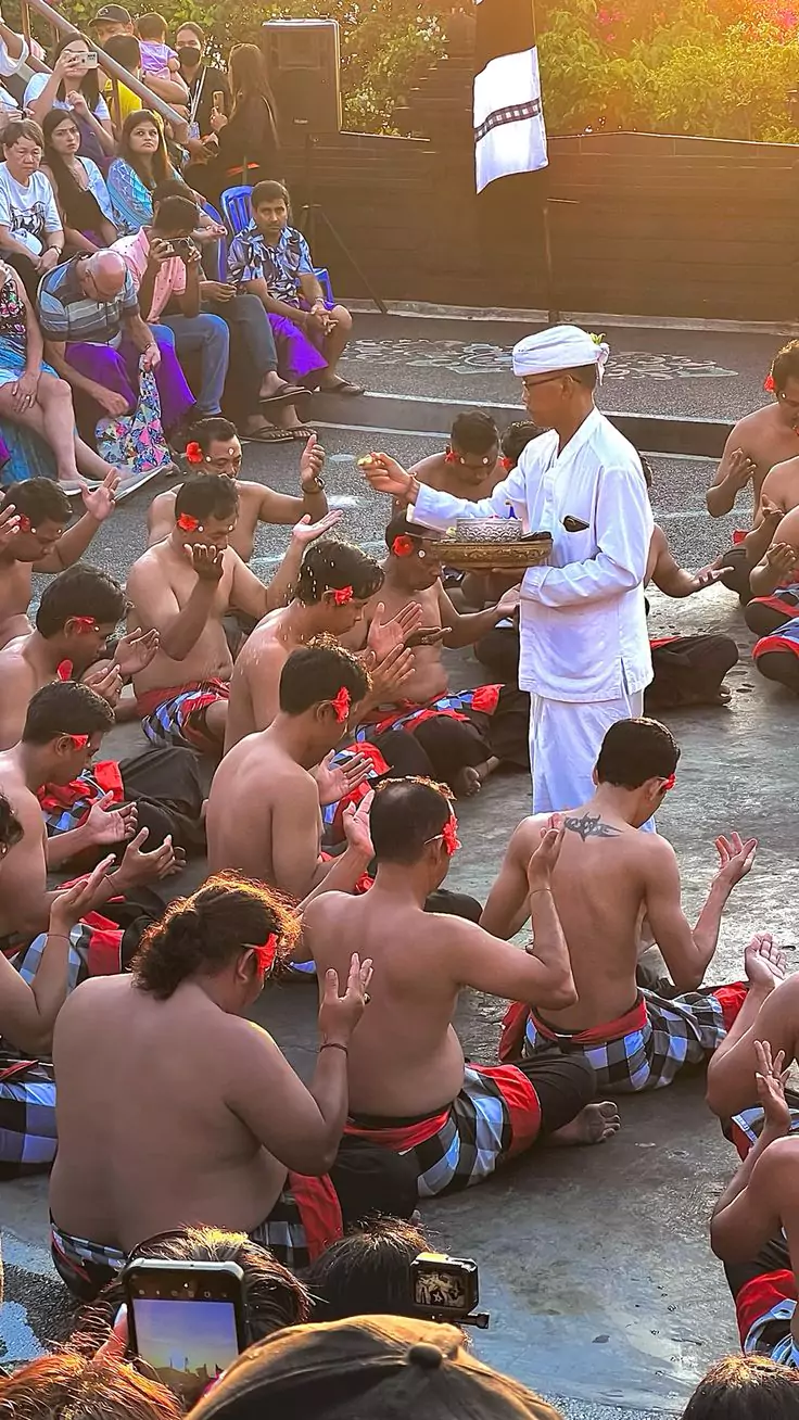 The blessing of the performers and the venue by the pemangku before the kecak uluwatu performance begins. This is a mandatory ritual