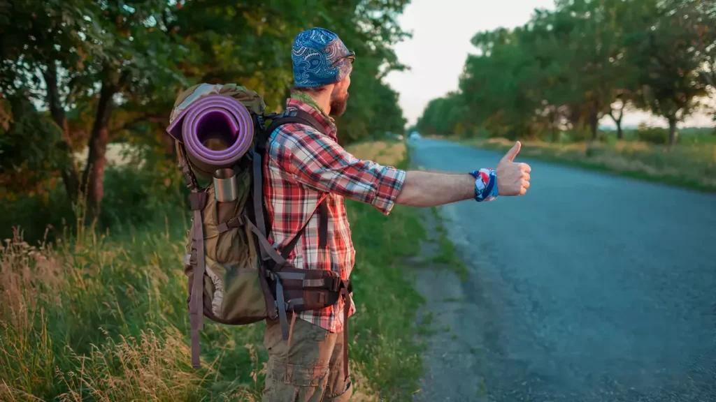 Bali tourism issues - Photo Illustration of a backpacker asking for a ride on the highway