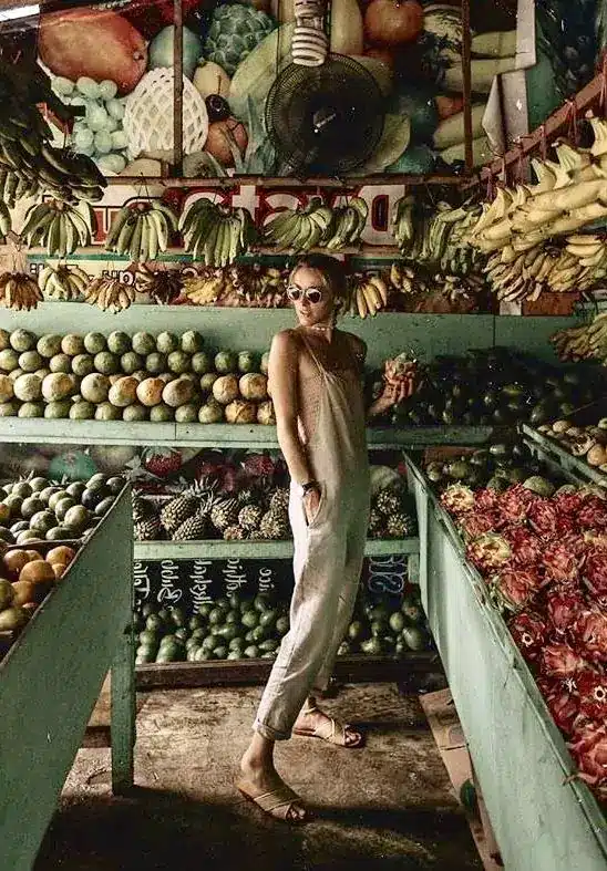 a Caucasian woman shopping at a traditional market in bali