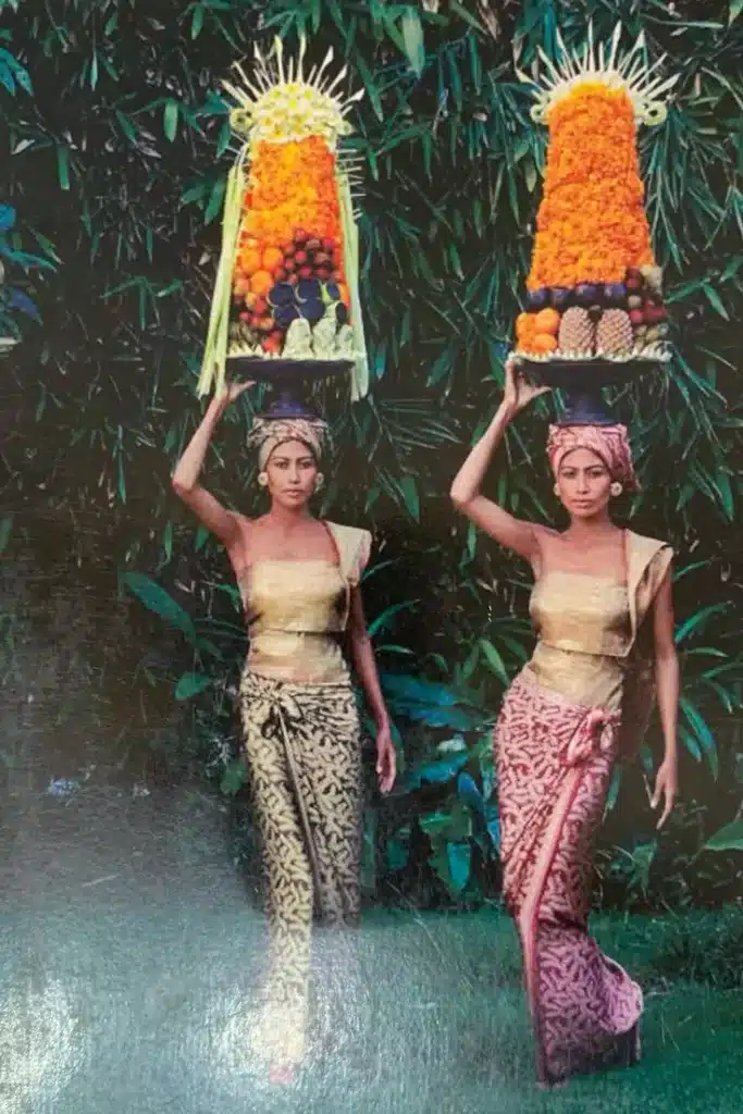 Two Caucasian women are wearing traditional Balinese clothes and look happy and posing. 