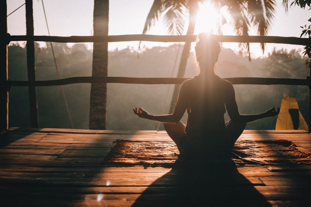 Photo of a Caucasian woman posing in yoga at a villa in Ubud at sunrise
