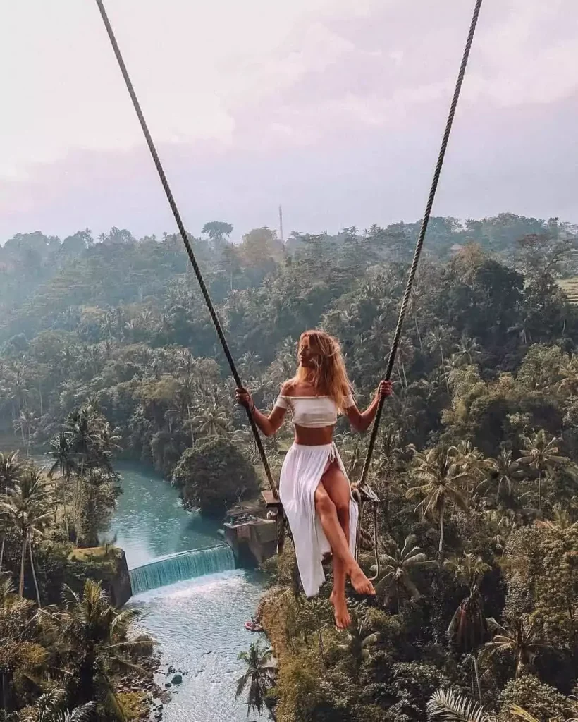 Photo of a Caucasian woman playing on a swing in Ubud