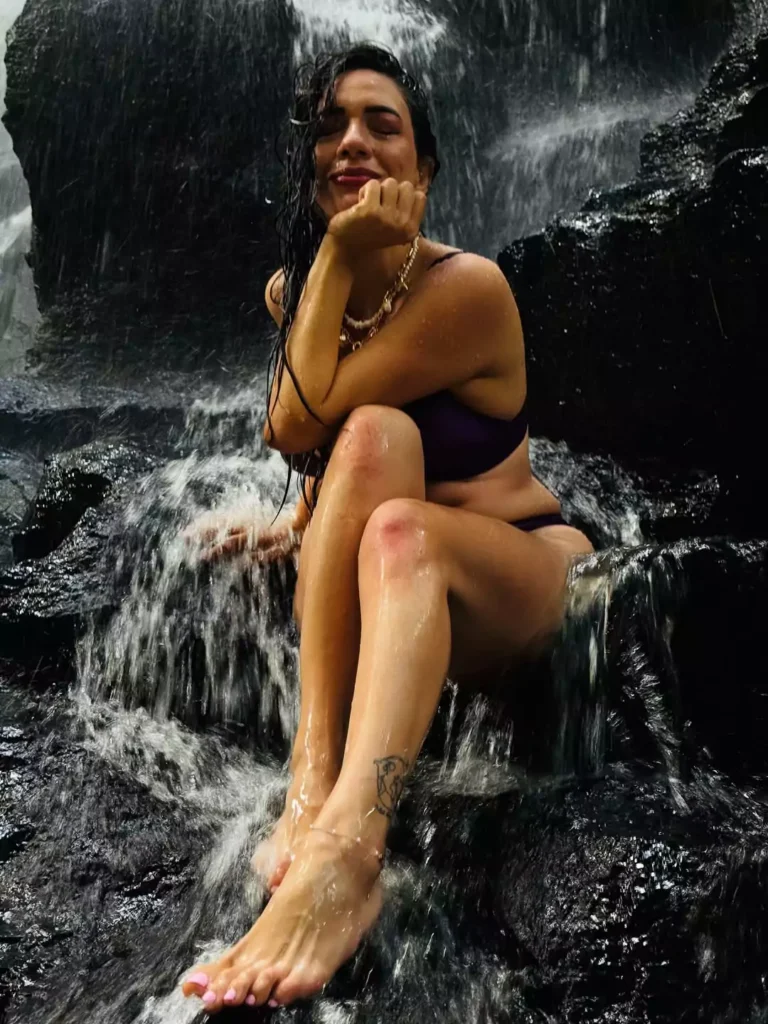 photo of a woman posing under a waterfall in Bali