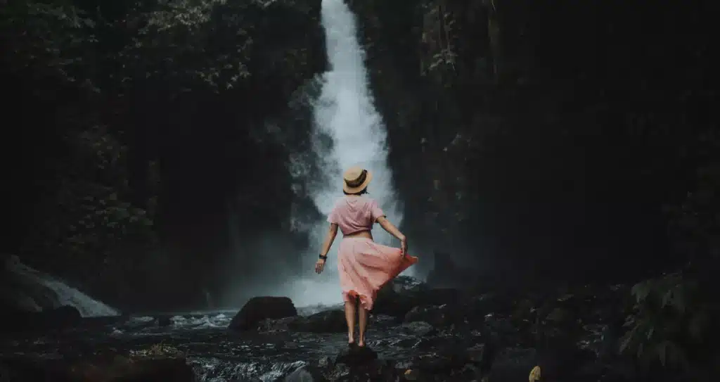 photo of a woman in a waterfall bali