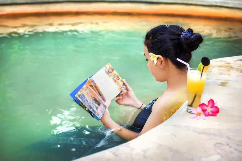 An Asian female tourist is relaxing in a hot spring in Bali.