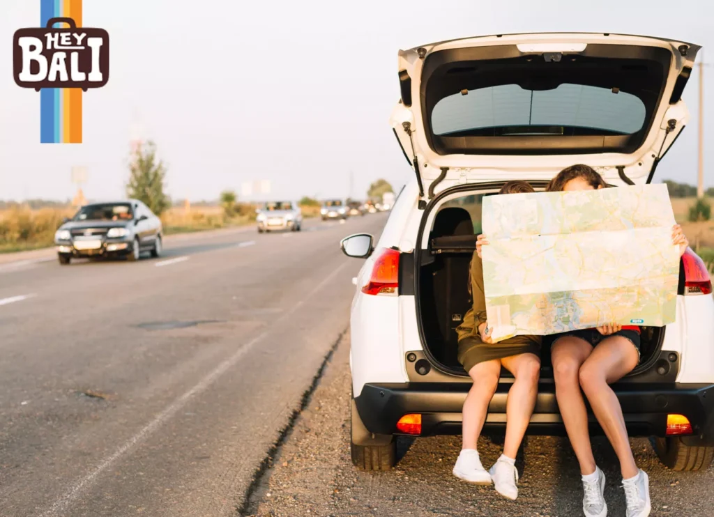 A pair of tourists are looking at a paper map and making sure their trip is correct and they don't get lost.
