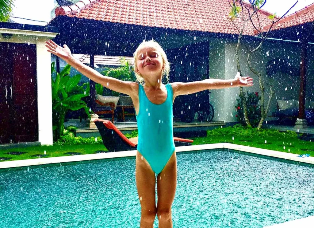 bali rainy season
- A girl from America is very happy and joyful enjoying the rain in a villa in Bali.